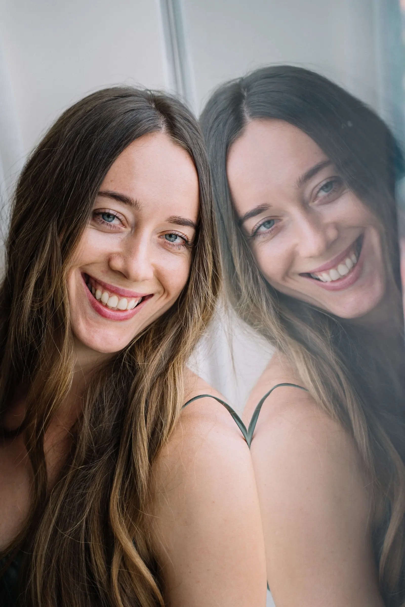 Two women laughing together, cheek to cheek